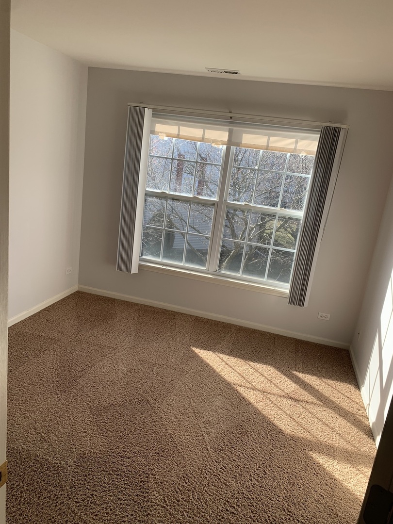 876 Stuarts Drive St. Charles, IL 60174 - Photo 7 of 8 a view of an empty room with a window