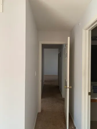 a view of a hallway with kitchen