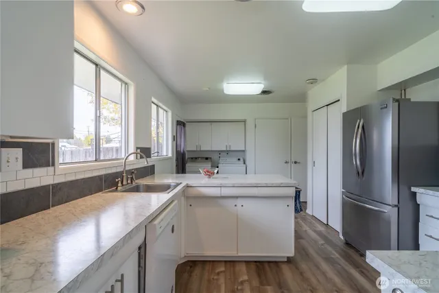 a kitchen with a sink stove and refrigerator