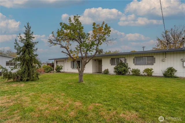 a front view of house with yard and trees