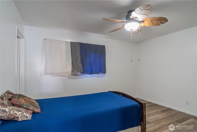 a room with furniture and chandelier fan