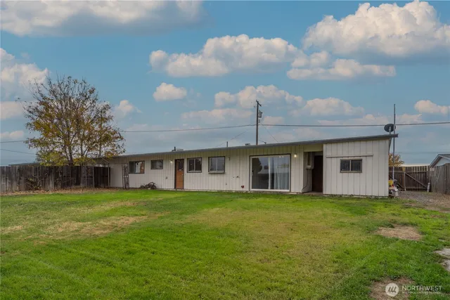 a view of a house with a big yard and large trees