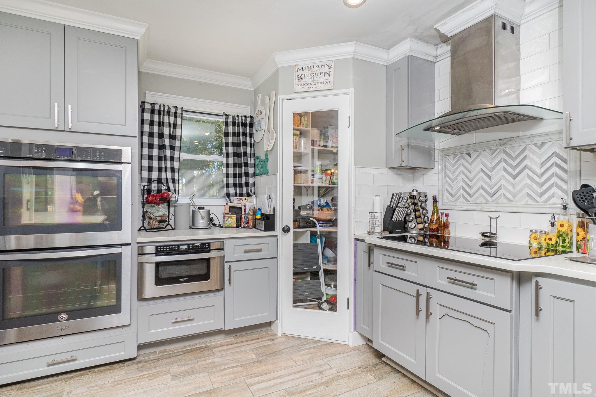 2207 Dorety Place Raleigh, NC 27604 - Photo 12 of 27 a kitchen with cabinets and stainless steel appliances