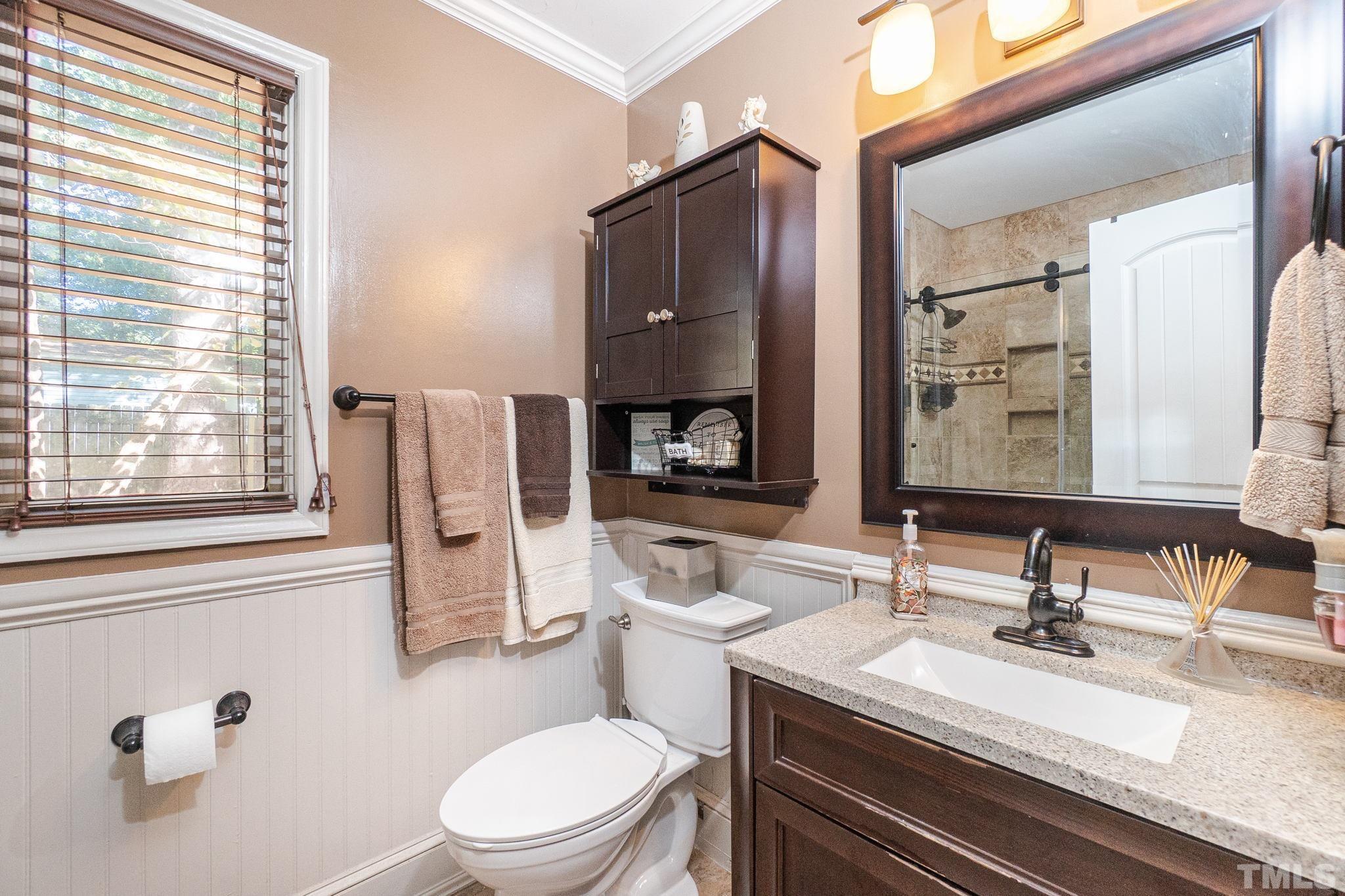 2207 Dorety Place Raleigh, NC 27604 - Photo 18 of 27 a bathroom with a granite countertop sink mirror vanity and toilet