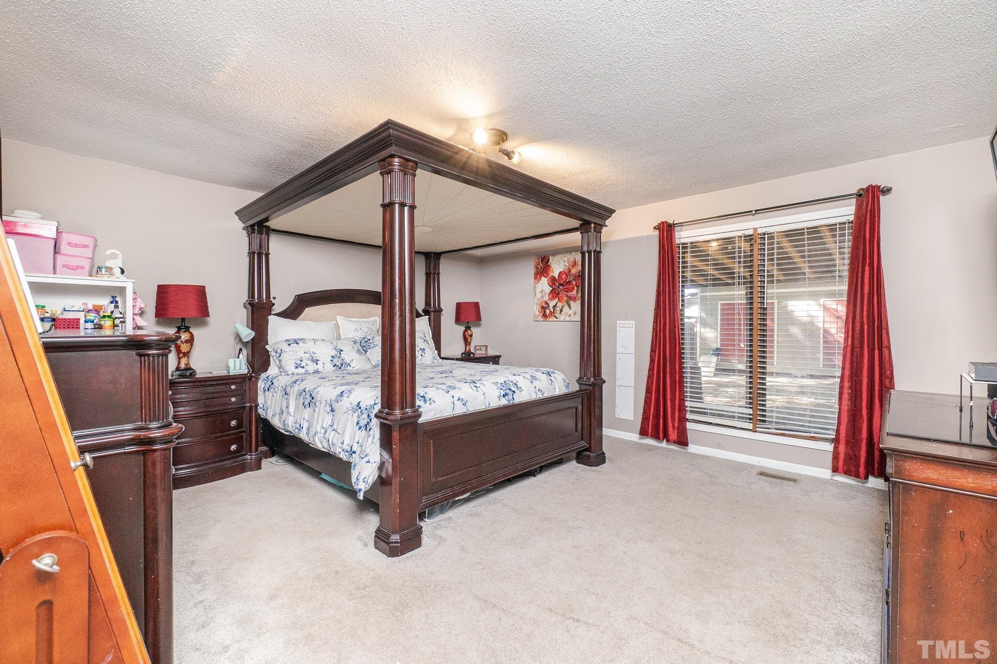 2207 Dorety Place Raleigh, NC 27604 - Photo 19 of 27 a bed room with a bed and a chair