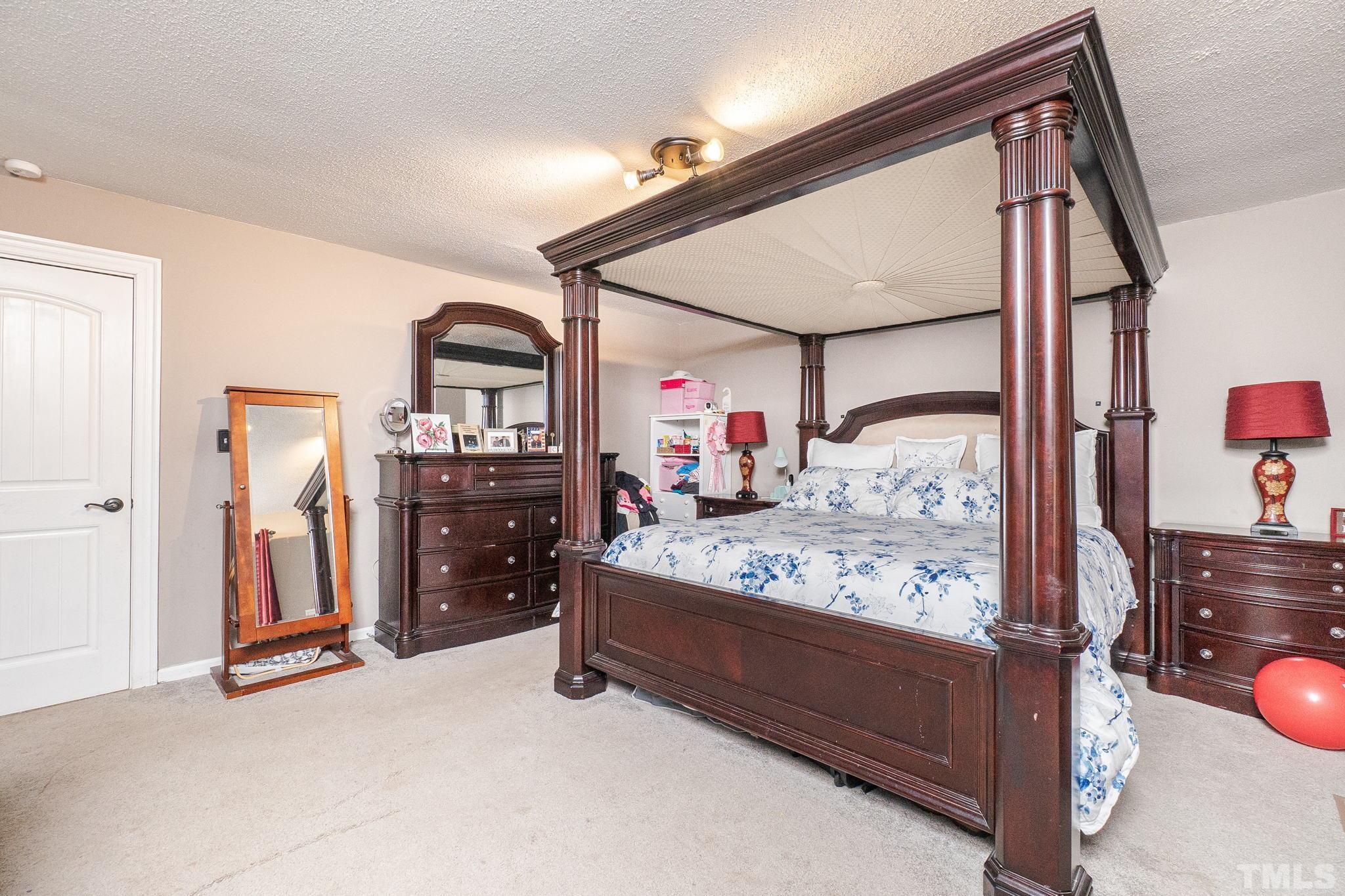2207 Dorety Place Raleigh, NC 27604 - Photo 20 of 27 a bed room with a bed and two mirror