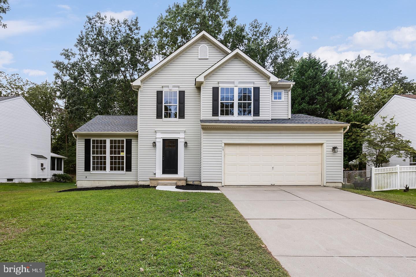 17 Arlington Road Sicklerville, NJ 08081 - Photo 1 of 43 a front view of a house with a garden and trees