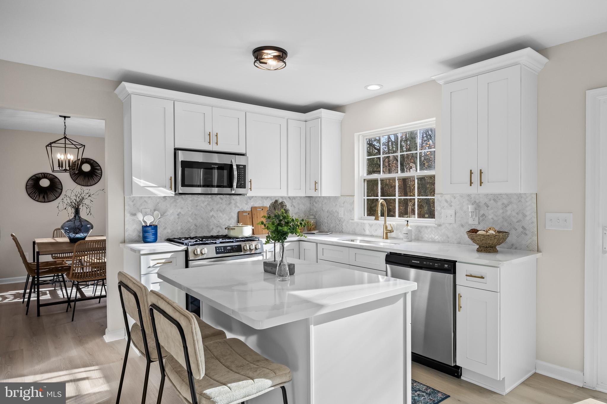 17 Arlington Road Sicklerville, NJ 08081 - Photo 13 of 43 a kitchen with a stove a sink and chairs