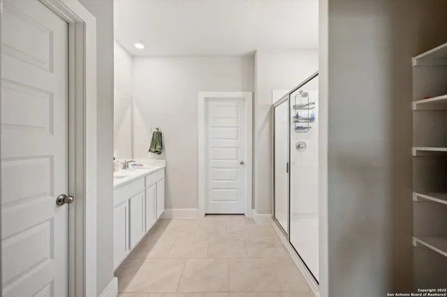 a bathroom with white cabinets