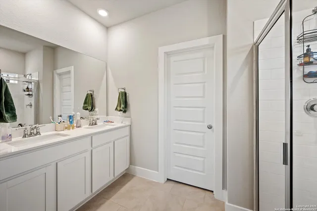 a bathroom with a double vanity sink and mirror