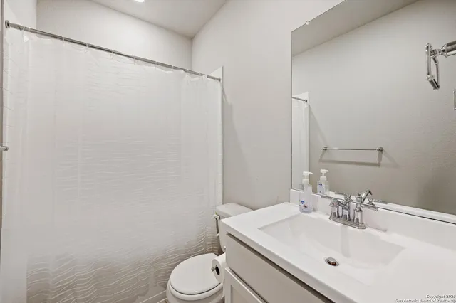 a bathroom with a sink toilet and vanity