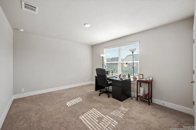 a view of workspace with furniture and a window