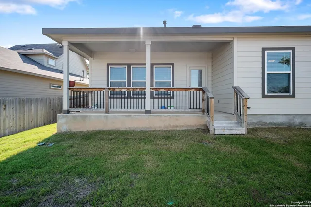 a view of a house with a yard and porch