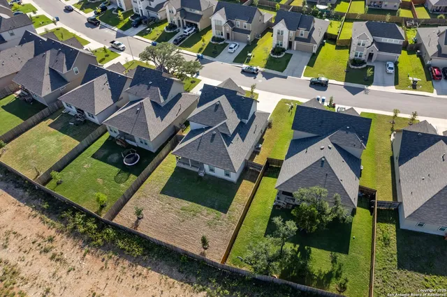 an aerial view of a house with a garden and swimming pool