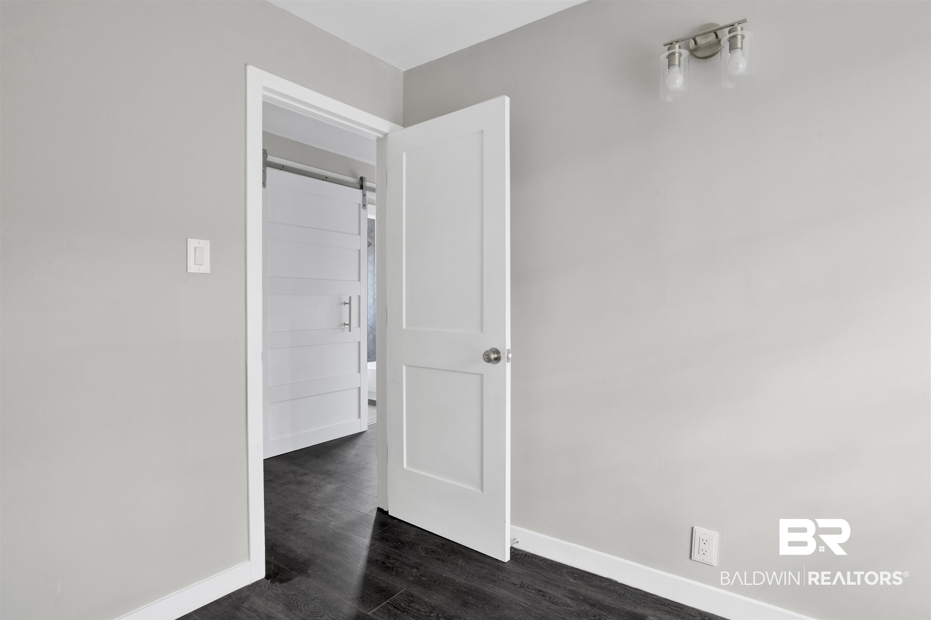 1063 Selma Street Mobile, AL 36604 - Photo 18 of 32 Unfurnished room with dark wood-style flooring and a barn door