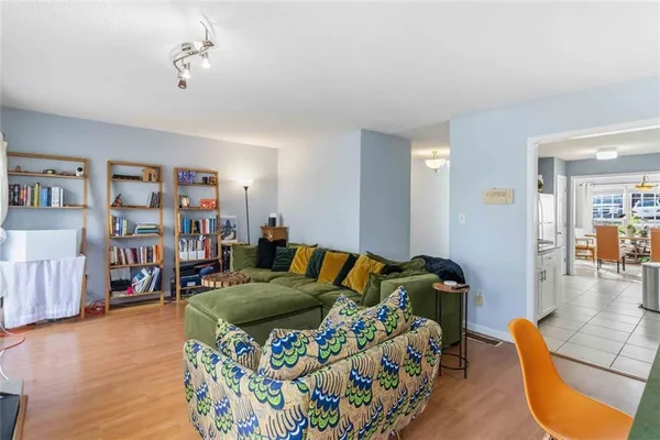 a bedroom with furniture and a wooden floor