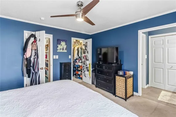 a living room with a flat screen tv and a walk in closet