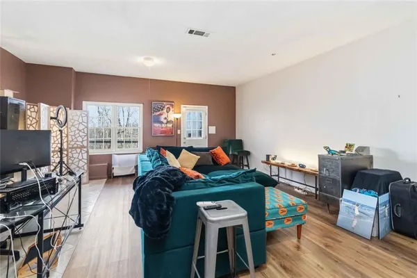 a living room with furniture and a wooden floor