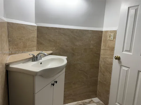 a bathroom with a sink and shower