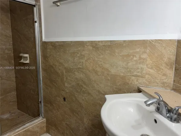 a view of a door and a living room