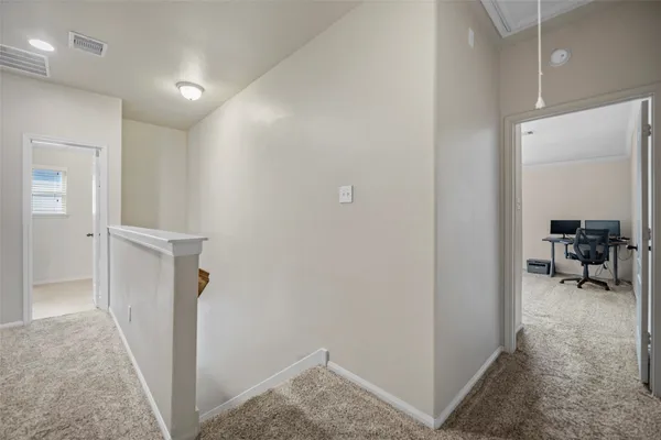 a view of hallway with livingroom and furniture