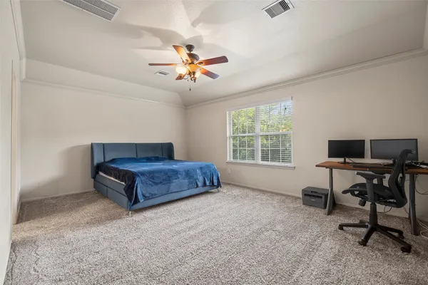a bedroom with a bed and a desk