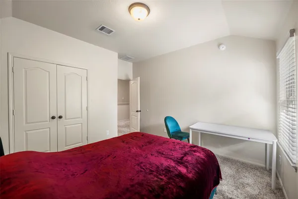 a bedroom with a bed and a closet