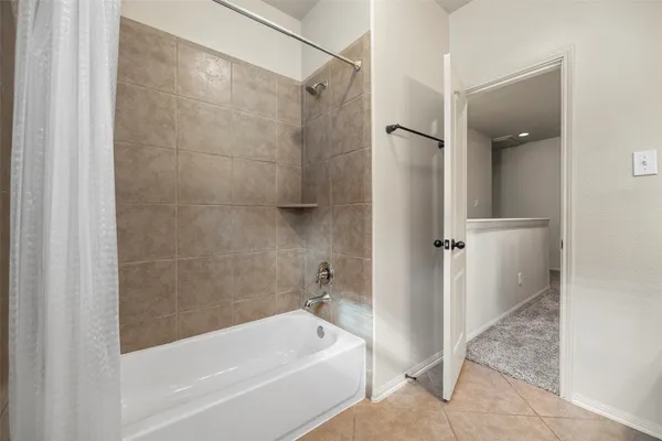 a bathroom with a tub and a shower