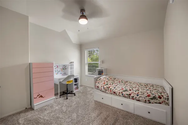 a bedroom with bed and a window