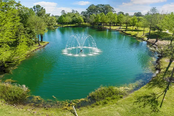 an aerial view of a residential houses with outdoor space and lake view