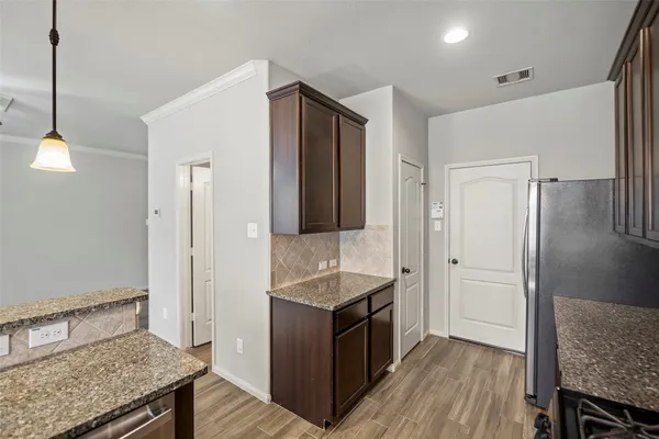a kitchen with a sink stove and refrigerator