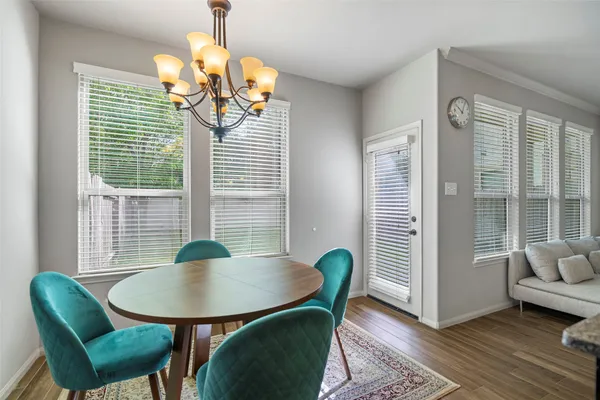 a view of a dining room with furniture and wooden floor