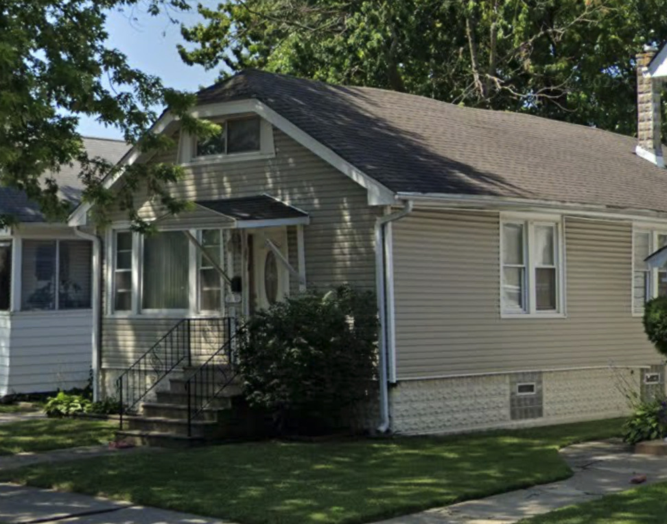 11030 South Union Avenue Chicago, IL 60628 - Photo 1 of 2 a front view of a house with a garden