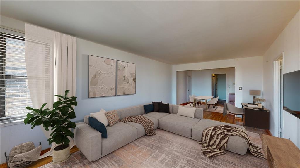 a living room with furniture window and potted plant