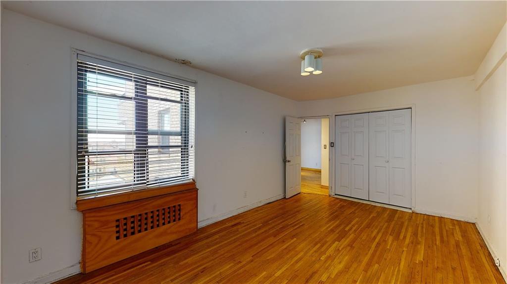 150 West End Avenue, Unit 5H Brooklyn, NY 11235 - Photo 11 of 17 a view of an empty room with wooden floor and a window