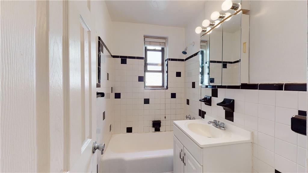 150 West End Avenue, Unit 5H Brooklyn, NY 11235 - Photo 13 of 17 a bathroom with a sink a toilet and a mirror