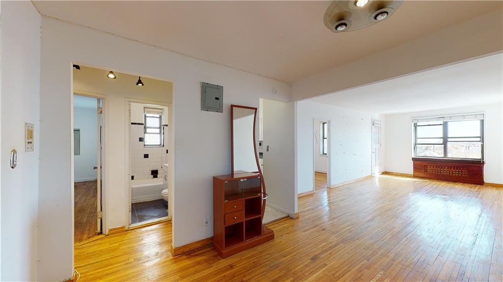 150 West End Avenue, Unit 5H Brooklyn, NY 11235 - Photo 3 of 17 an empty room with wooden floor and windows
