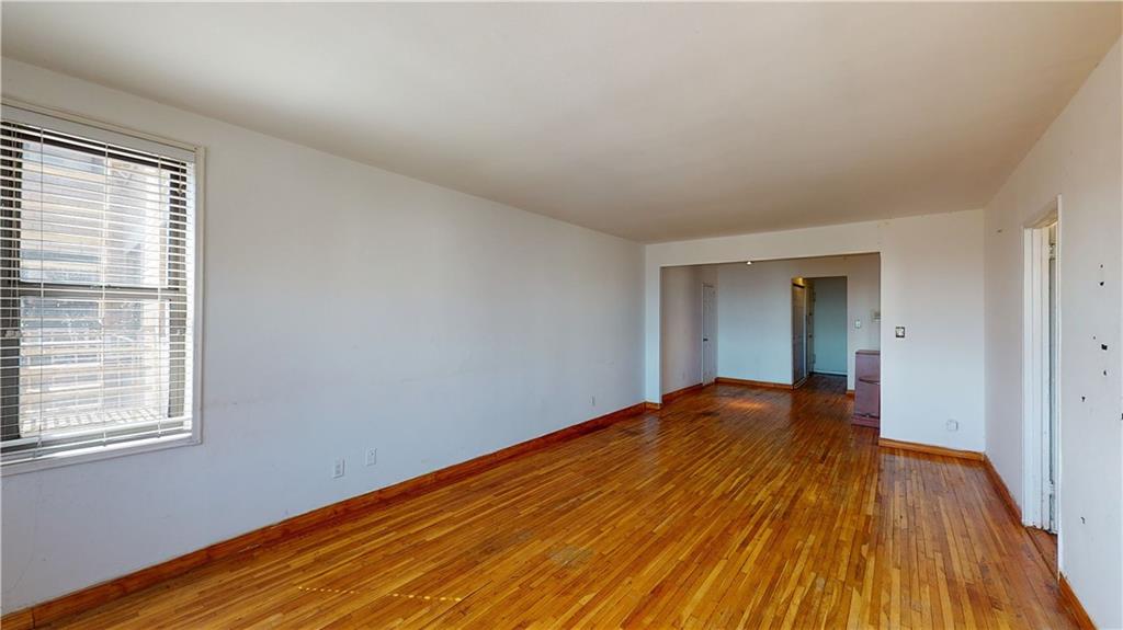150 West End Avenue, Unit 5H Brooklyn, NY 11235 - Photo 7 of 17 a view of an empty room with wooden floor and a window