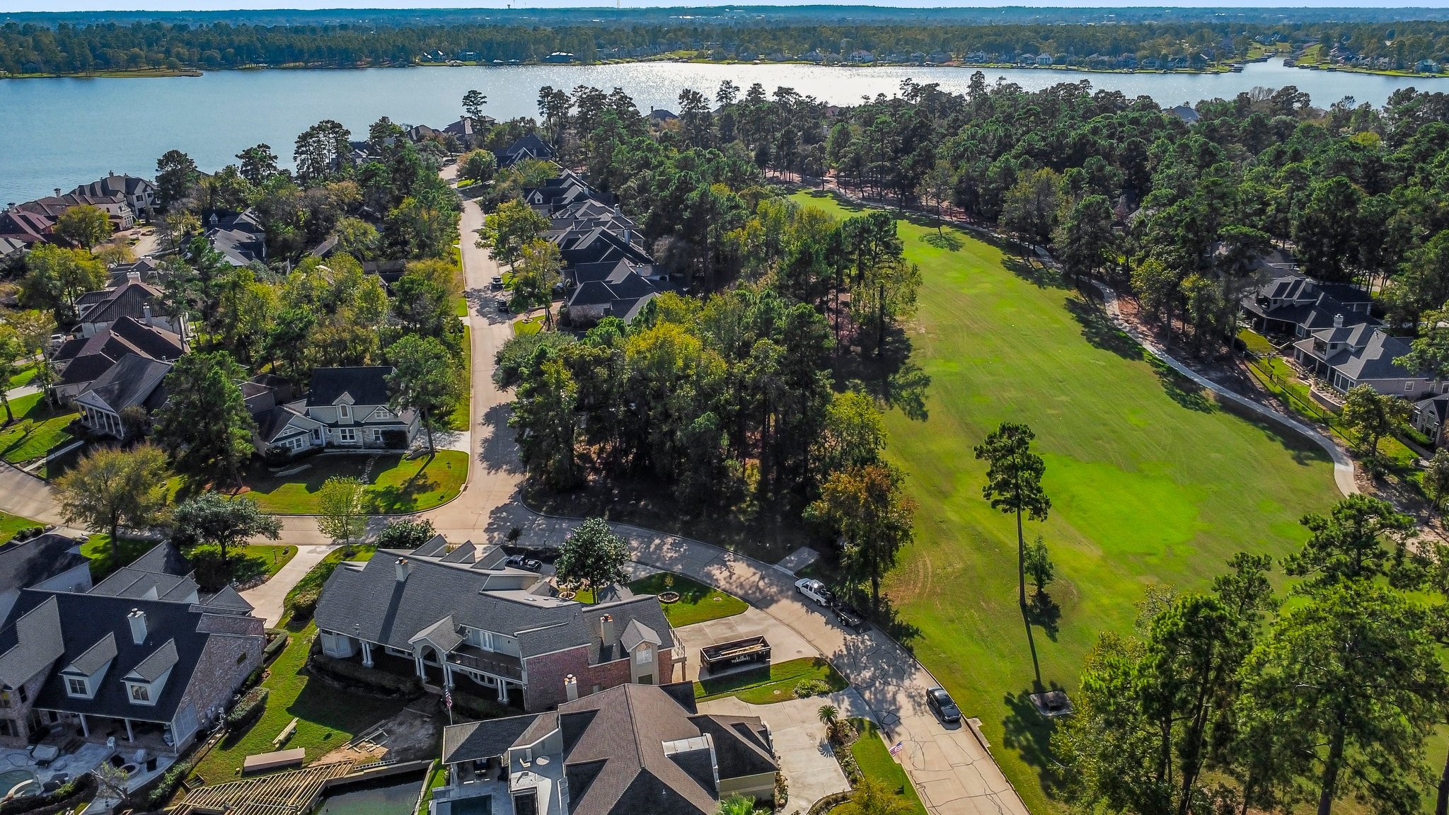 3 West Shore Lane Montgomery, TX 77356 - Photo 45 of 50 a view of a lake with a building in the background