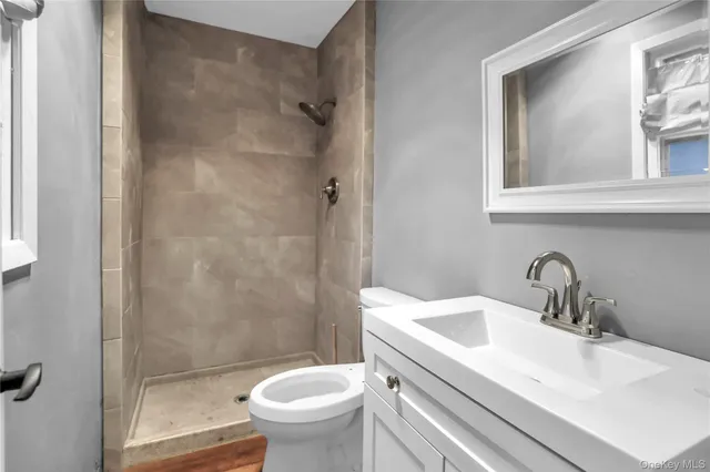 a bathroom with a sink a toilet and shower