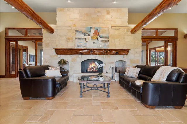 a living room with patio furniture and a large window