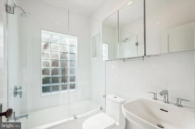 a bathroom with a toilet sink and a shower