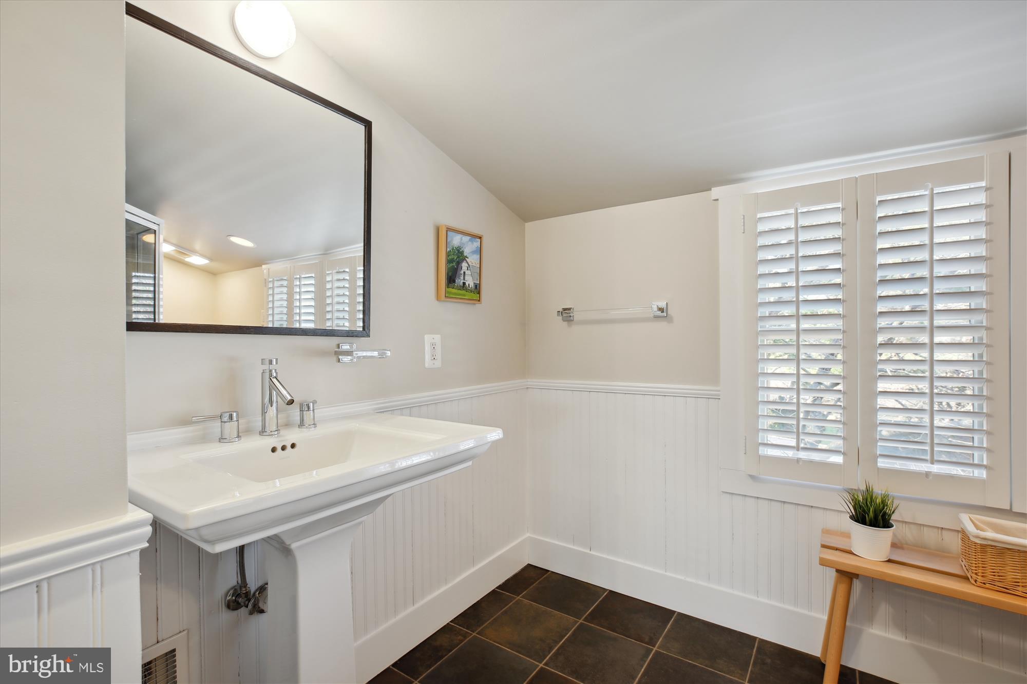 9411 Garwood Street Silver Spring, MD 20901 - Photo 47 of 90 a bathroom with a sink and a mirror