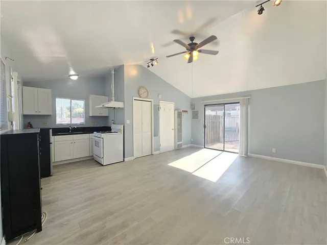 a kitchen with a refrigerator and white cabinets