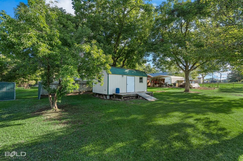 202 Butler Street Springhill, LA 71075 - Photo 9 of 38 a view of a backyard with large trees
