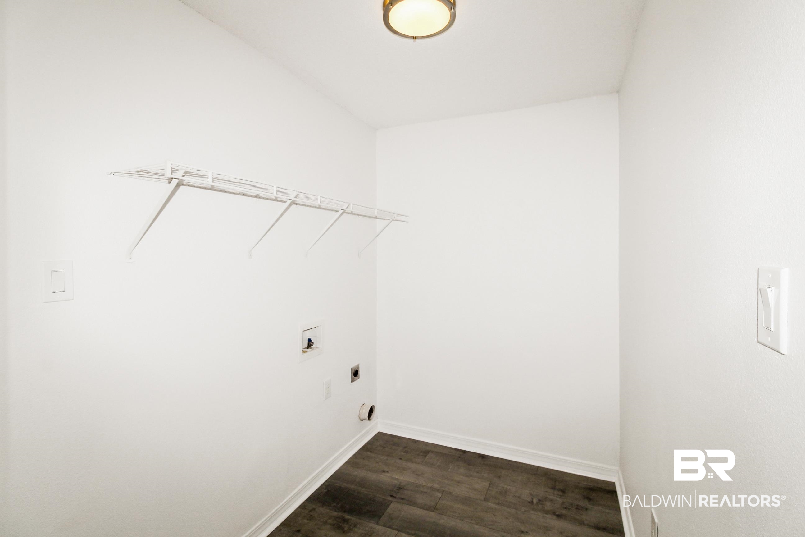 14750 Pawnee Court Foley, AL 36535 - Photo 30 of 34 Laundry room with electric dryer hookup and dark wood-style floors