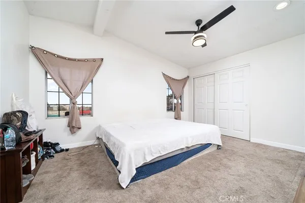 a bedroom with a bed a window and gym equipment