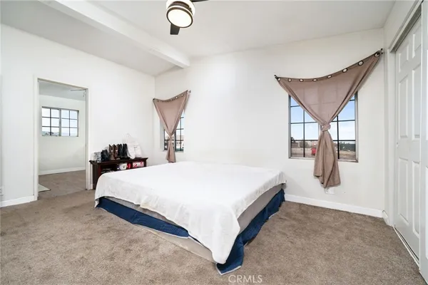 a spacious bedroom with a bed and window