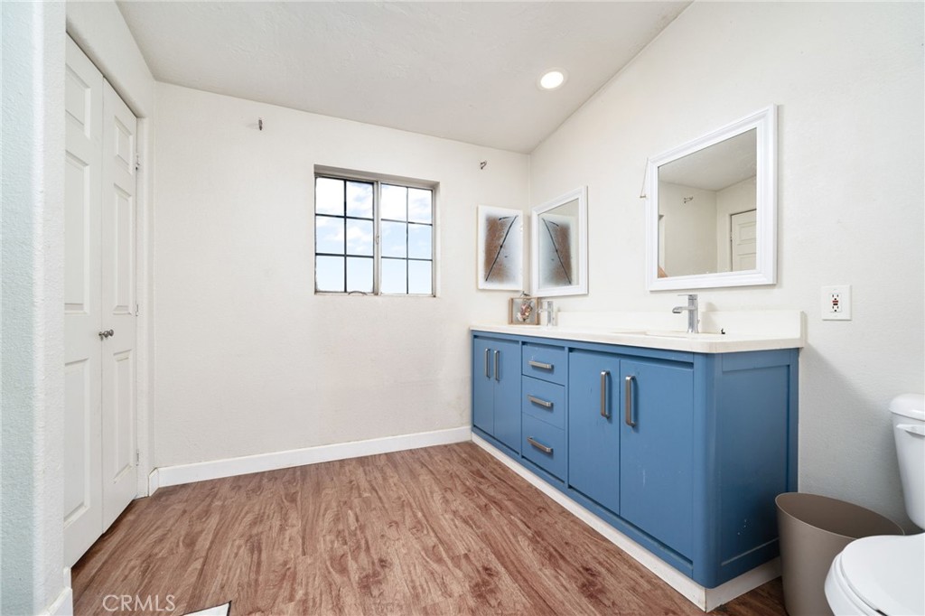 13221 Arena Road Pinon Hills, CA 92372 - Photo 16 of 19 a bathroom with a sink a toilet a mirror and window