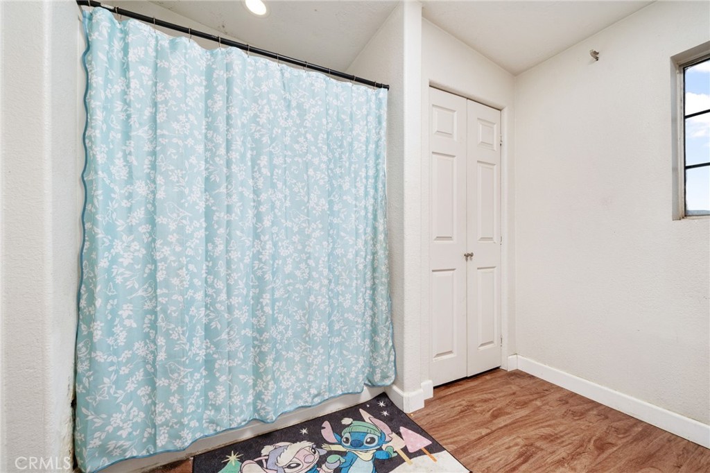 13221 Arena Road Pinon Hills, CA 92372 - Photo 17 of 19 a view of a room with wooden floor and a window